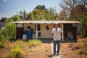 Picture of man outside the small building – MWF funded this Dairy Co-Op and this is where they make yogurt and cheese from the cows.