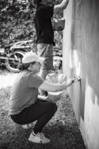 Shannon painting a new building structure.